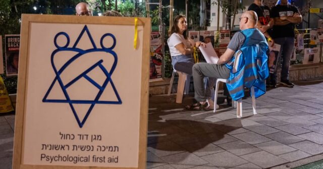 TEL AVIV, ISRAEL - OCTOBER 31: Psychological first aid workers sit with people at families of hostages protest location outside The Kirya (HaKirya) on October 31, 2023 in Tel Aviv, Israel. As Israel's response to Hamas's Oct 7 attacks entered its fourth week, the Israeli PM said the current war would be a long one and would amount to a "second war of independence." In the wake Hamas's attacks that left an estimated 1,400 dead and 230 kidnapped, Israel launched a sustained bombardment of the Gaza Strip and b